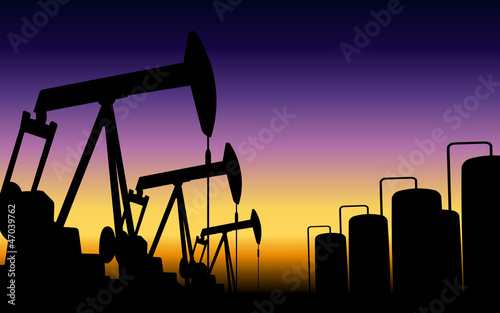 silhouette of working oil pumps on sunset background