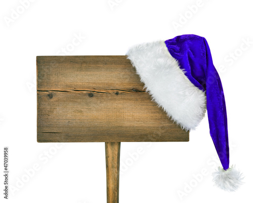 wooden road sign with Santa hat isolated on a white background