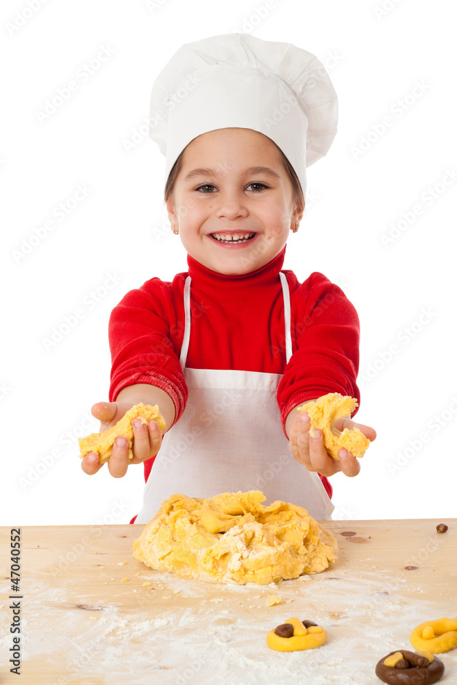 Little girl kneading the dough