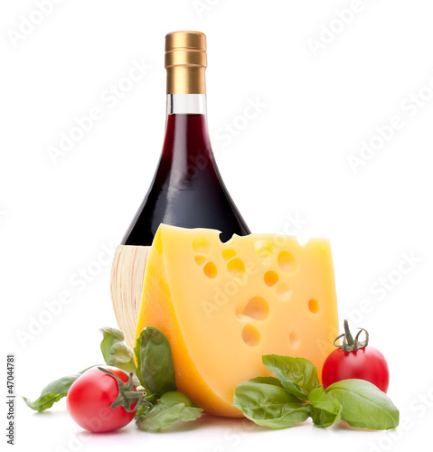 Red wine bottle, cheese and tomato still life
