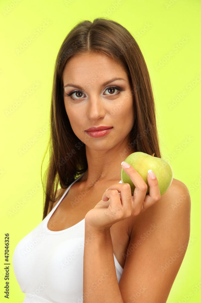 beautiful young woman with green apple, on green background beautiful young woman with green apple, on green background
