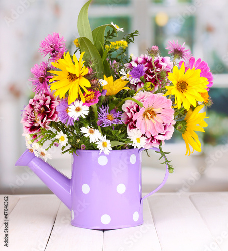 beautiful bouquet of bright flowers in watering can