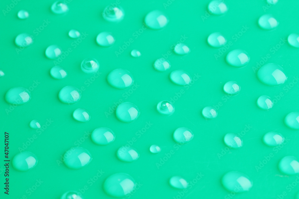 Water drops on green background