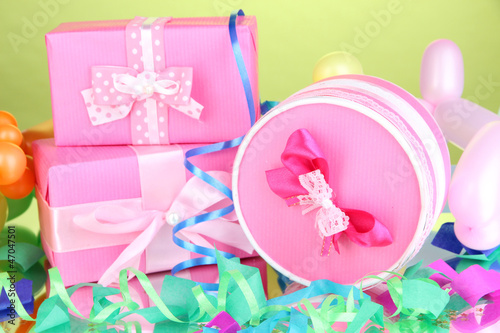 Colorful gift boxes on green background
