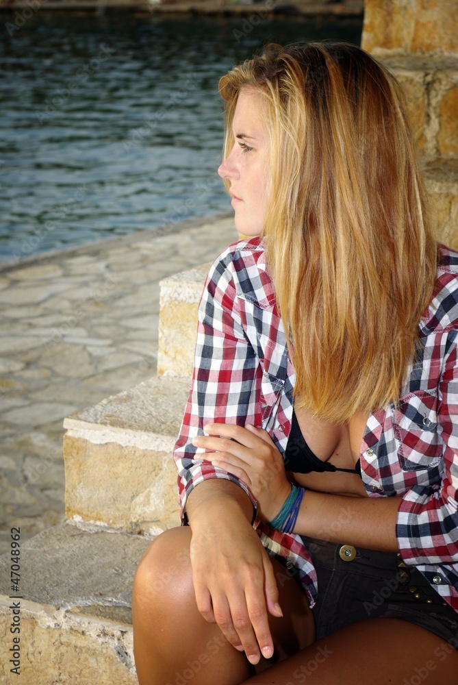 Attractive young woman posing on the beach