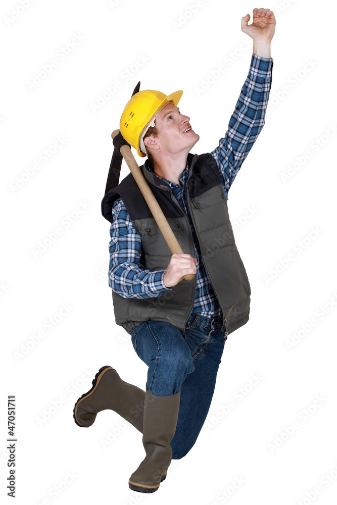 bricklayer holding pickaxe looking upwards bricklayer holding pickaxe looking upwards