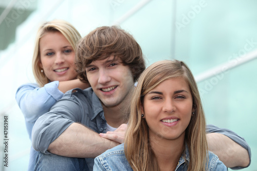 three students sitting on stairs