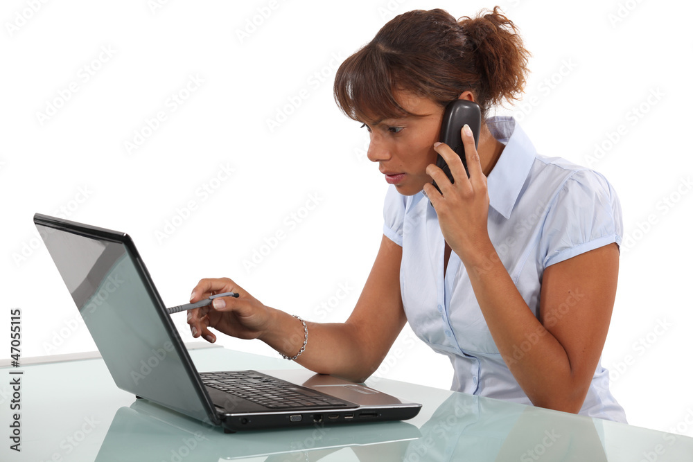 Woman telephoning technical help desk Woman telephoning technical help desk