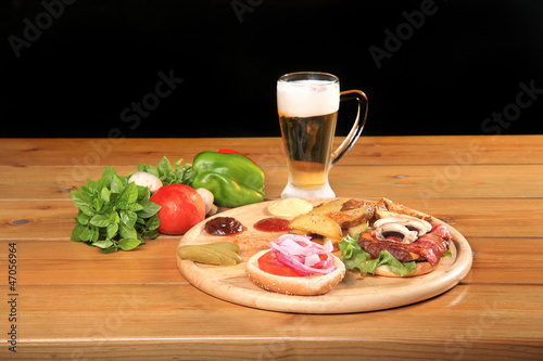beef burger on a plate with vegetables