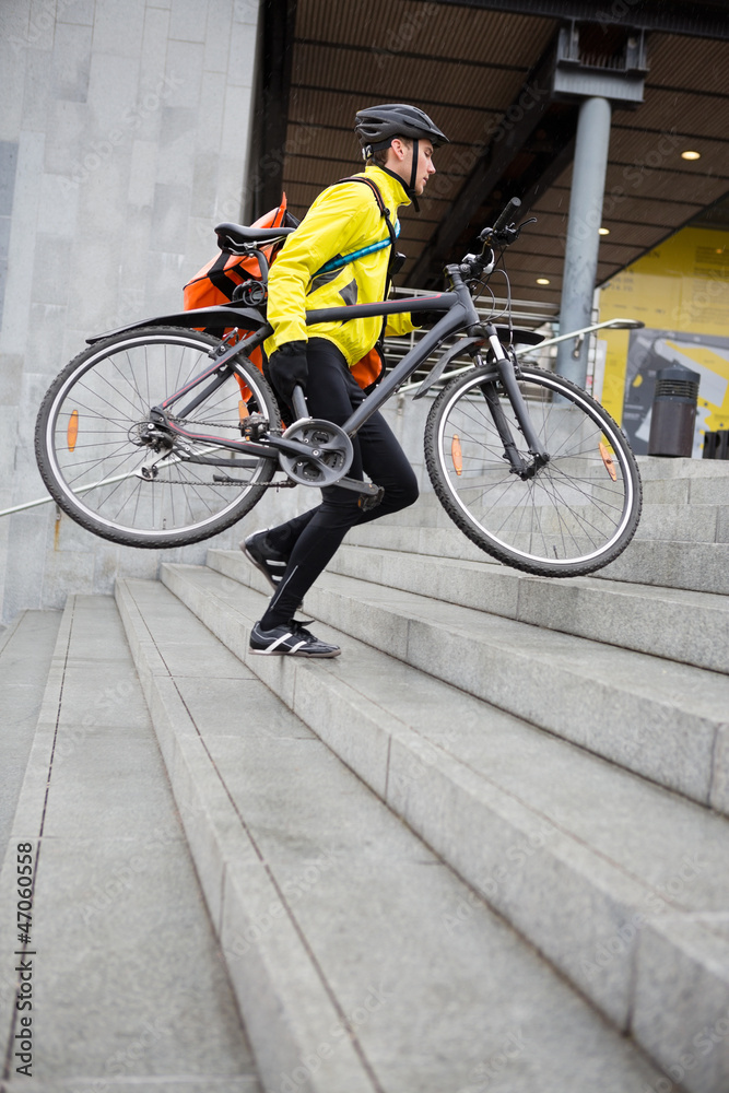 Courier Delivery Man With Bicycle And Backpack Walking Up Steps
