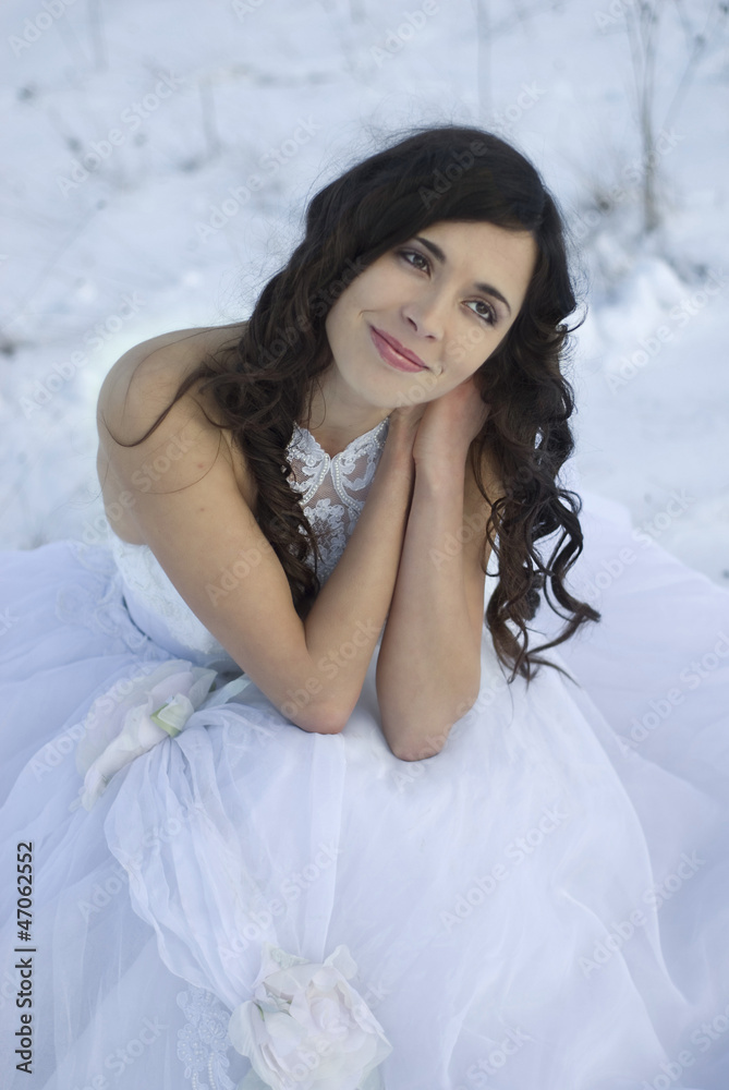 pretty young woman posing in wedding dress on winter snow pretty young woman posing in wedding dress on winter snow
