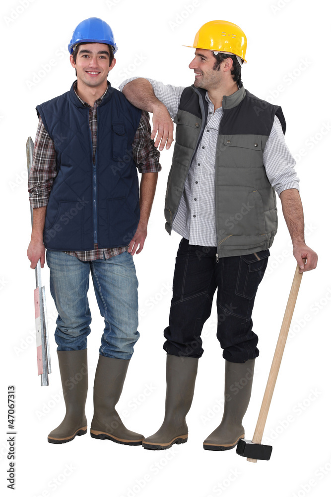 Two manual workers stood together Two manual workers stood together