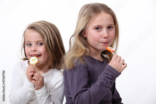 Little girls eating candy