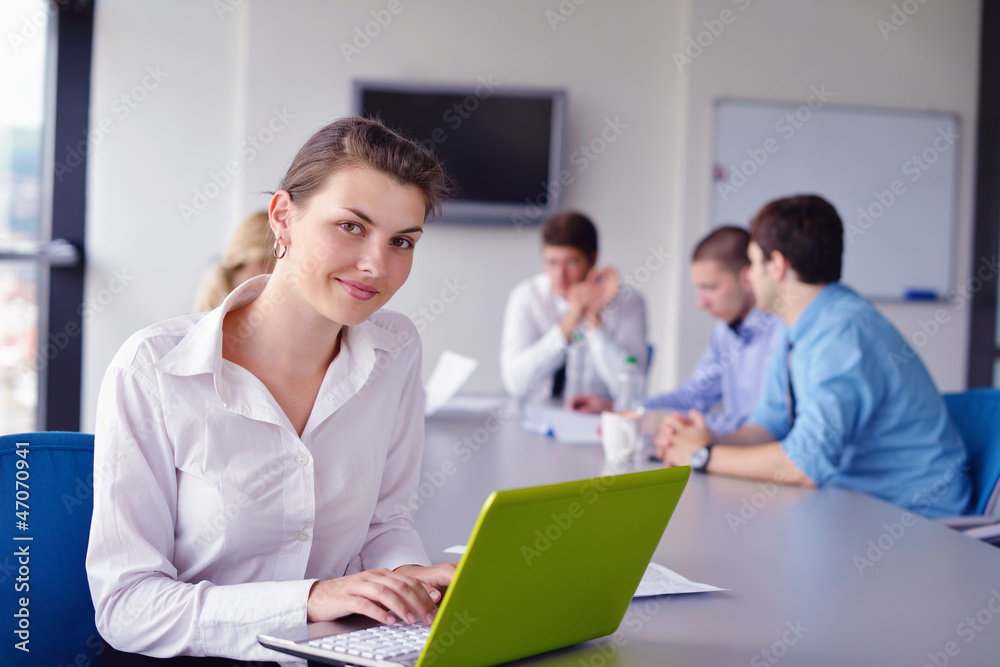 business woman with her staff in background at office business woman with her staff in background at office