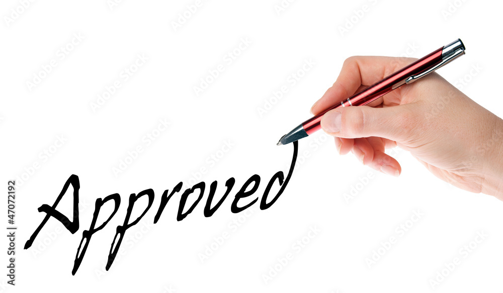 Hand with pen writes approved Hand with pen writes approved