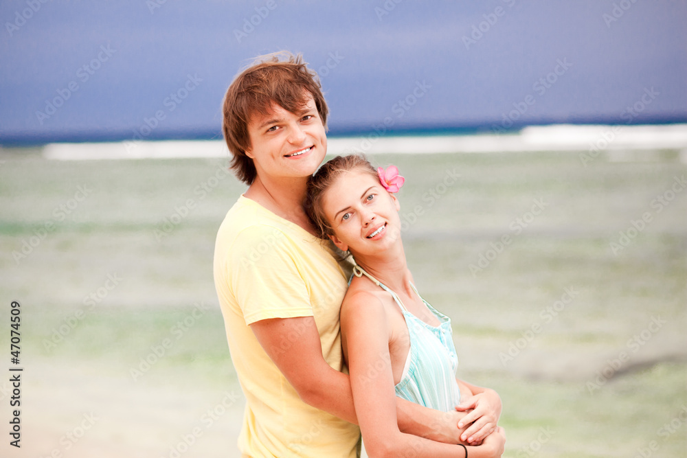 young happy couple having fun on tropical beach. honeymoon young happy couple having fun on tropical beach. honeymoon