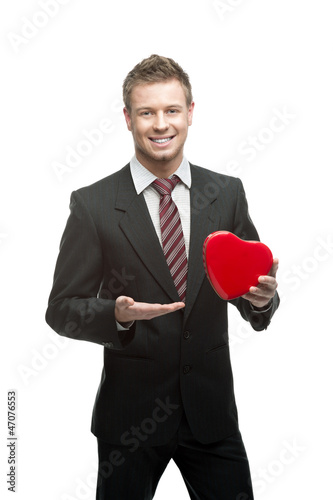 young cheerful businessman holding red heart © photo-nuke