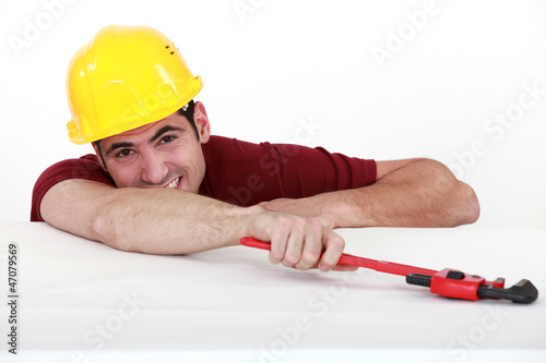 Man holding adjustable wrench