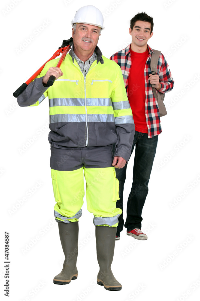 Builder stood with eager new apprentice Builder stood with eager new apprentice
