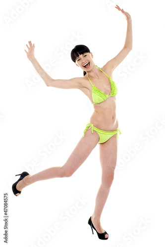 Joyous woman in green lingerie dancing in joy