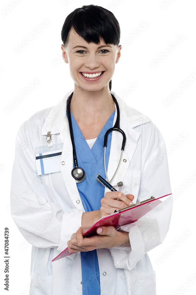 Friendly doctor updating medical record of a patient Friendly doctor updating medical record of a patient
