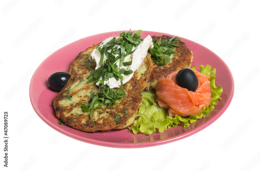 Roasted cutlets of potato with salmon on a plate