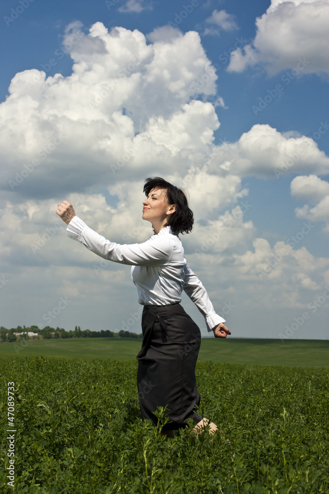 Successful businesswoman standing at the green grass Successful businesswoman standing at the green grass