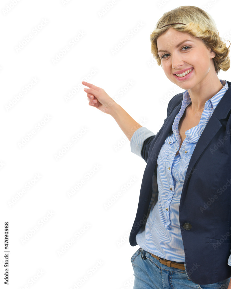 Happy teenage girl pointing back on copy space Happy teenage girl pointing back on copy space