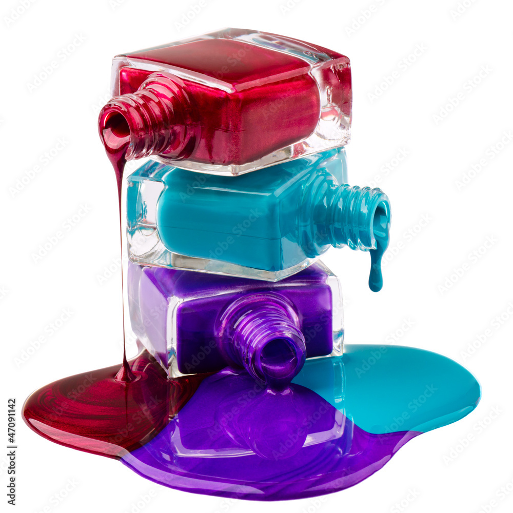 Bottles with spilled nail polish over white background Bottles with spilled nail polish over white background