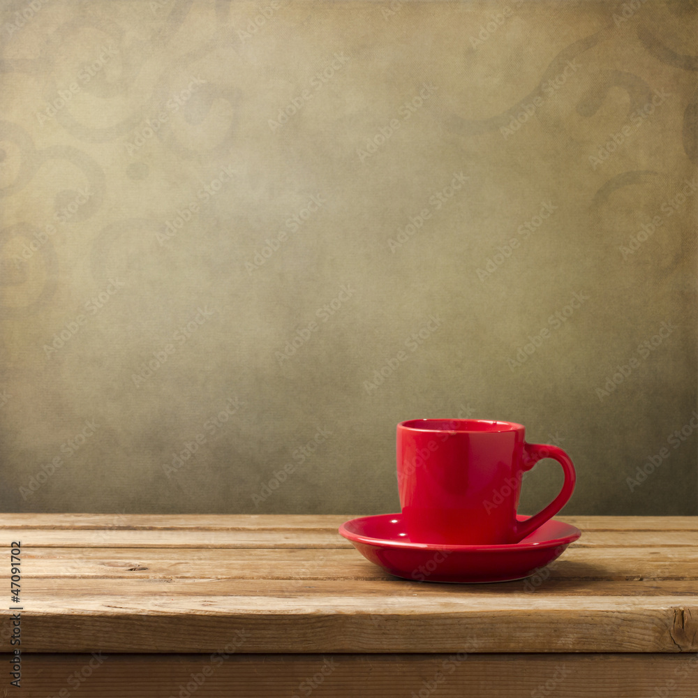 Red coffee cup on wooden table Red coffee cup on wooden table