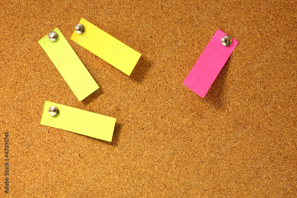 Post-it notes pushpins on cork board. Post-it notes pushpins on cork board.