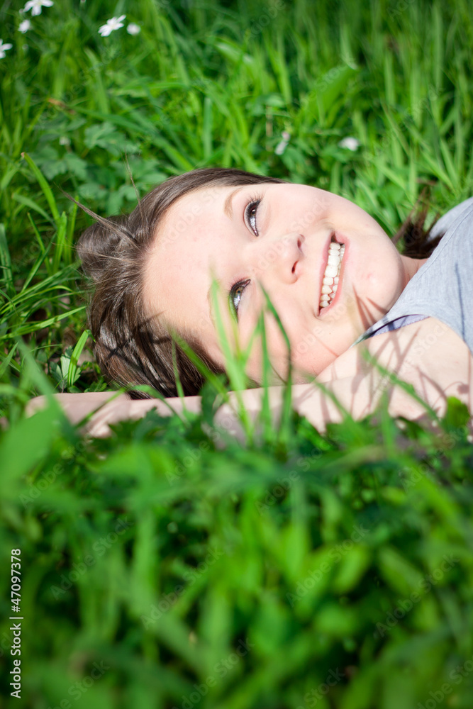 Closeup of a young girl relaxing in grass Closeup of a young girl relaxing in grass