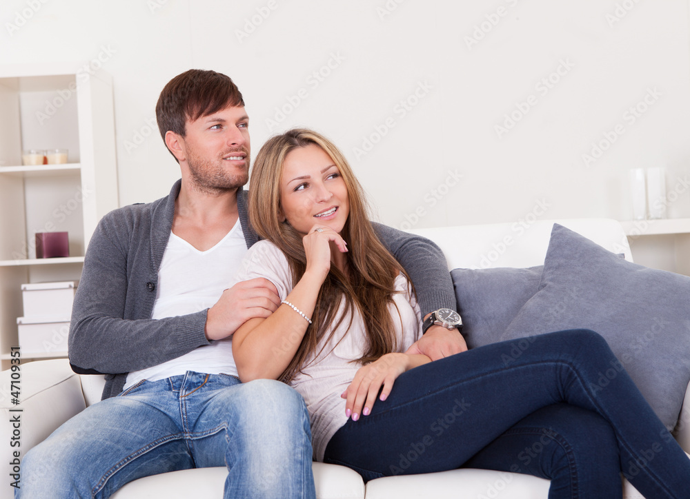 Cheerful young couple dreaming about the future