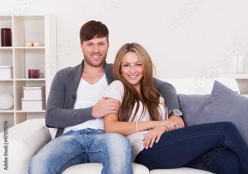 Couple sit on new couch