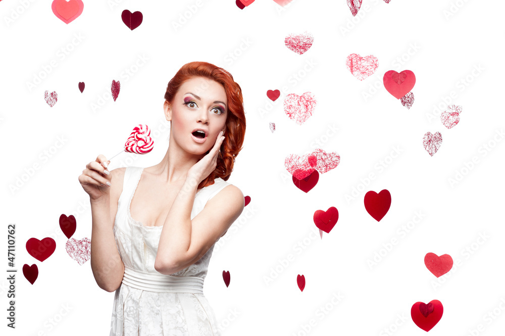 surprised red-haired woman holding lollipop surprised red-haired woman holding lollipop