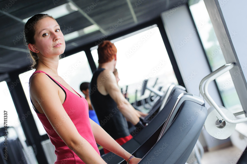 Running on treadmill in gym or fitness club Running on treadmill in gym or fitness club