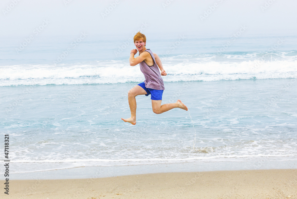 cute young teenage boy has fun at the beach cute young teenage boy has fun at the beach