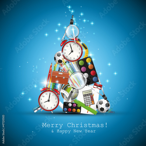 Christmas tree made from school supplies on blue background