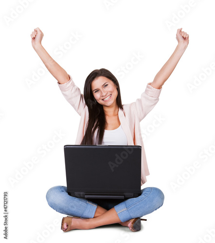 Woman sitting rejoicing with her laptop © Andrey Popov