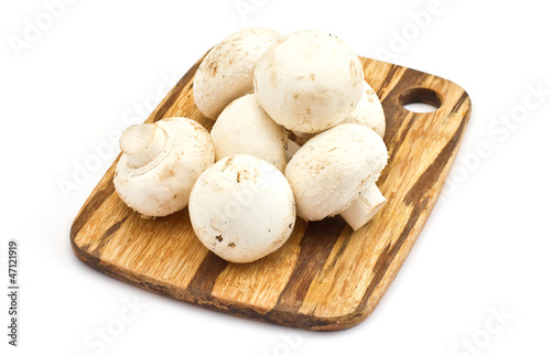 Fresh mushrooms on wooden board isolated on white