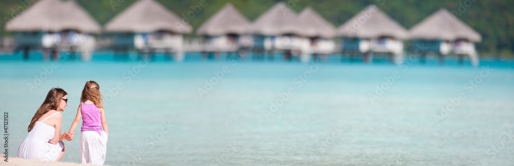 Mother and daughter at resort beach