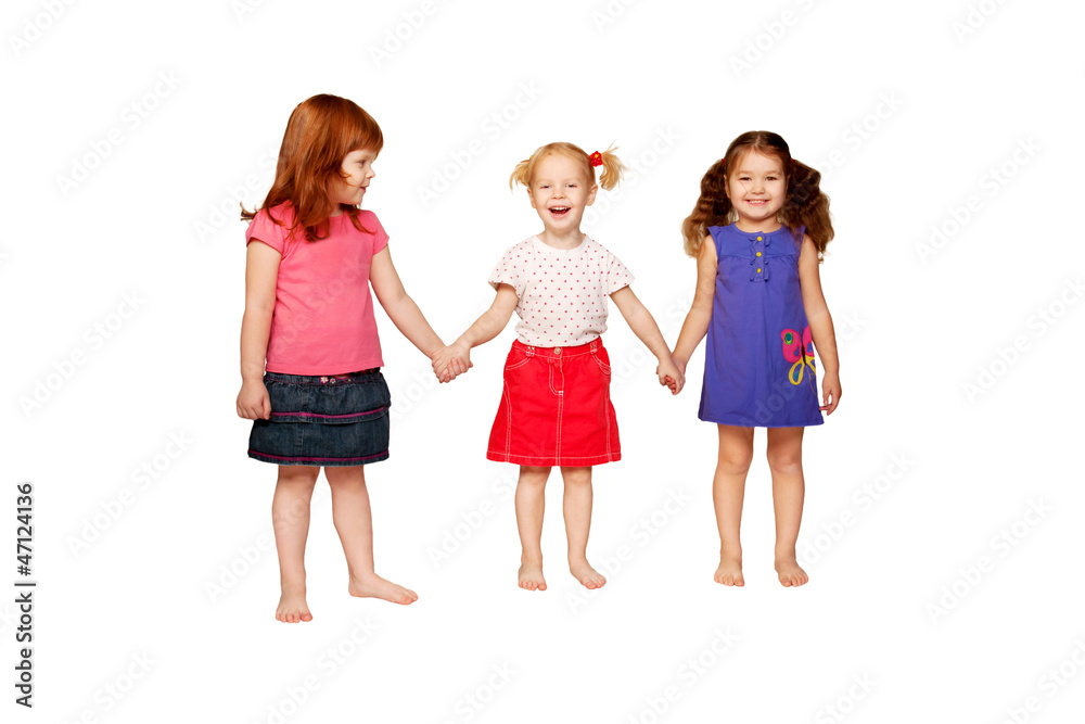 Three lovely smiling little girls holding hands. Three lovely smiling little girls holding hands.