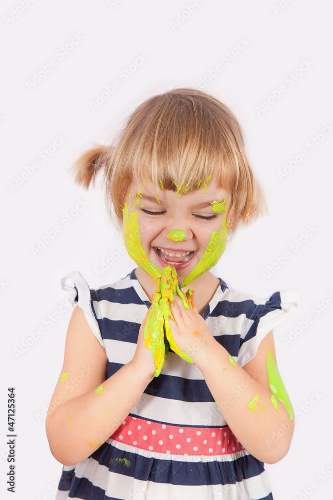Small girl with paint on her cheek and nose Small girl with paint on her cheek and nose