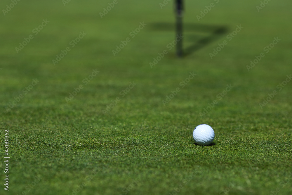 golf ball on lip of cup golf ball on lip of cup