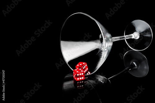 two red dice in a cocktail glass