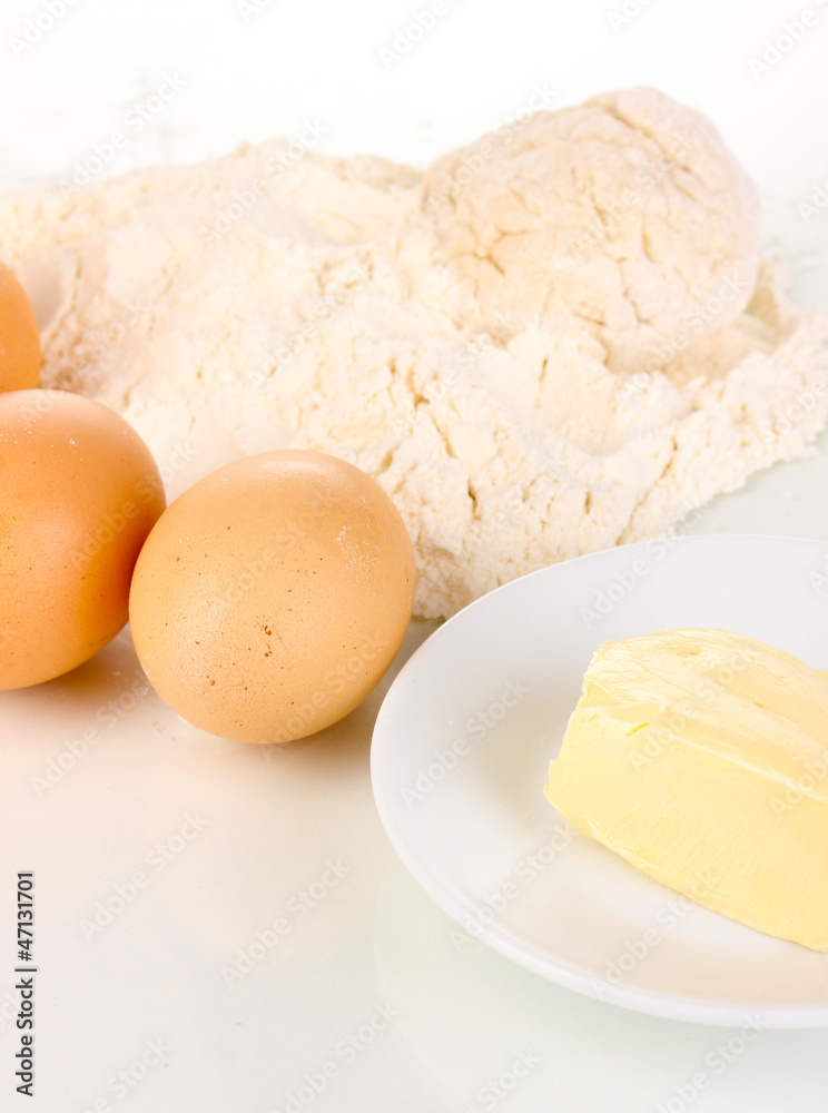 Eggs, flour and butter close-up isolated on white Eggs, flour and butter close-up isolated on white