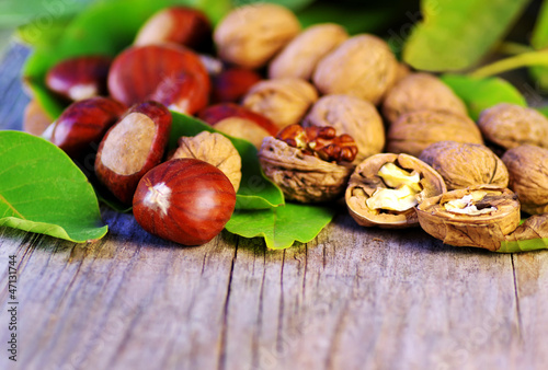 chestnuts and walnuts on wooden table