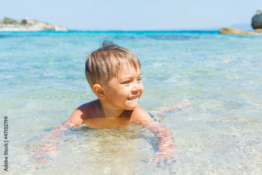 Cute boy playing in the sea