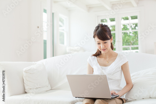 Beautiful young woman using a laptop computer