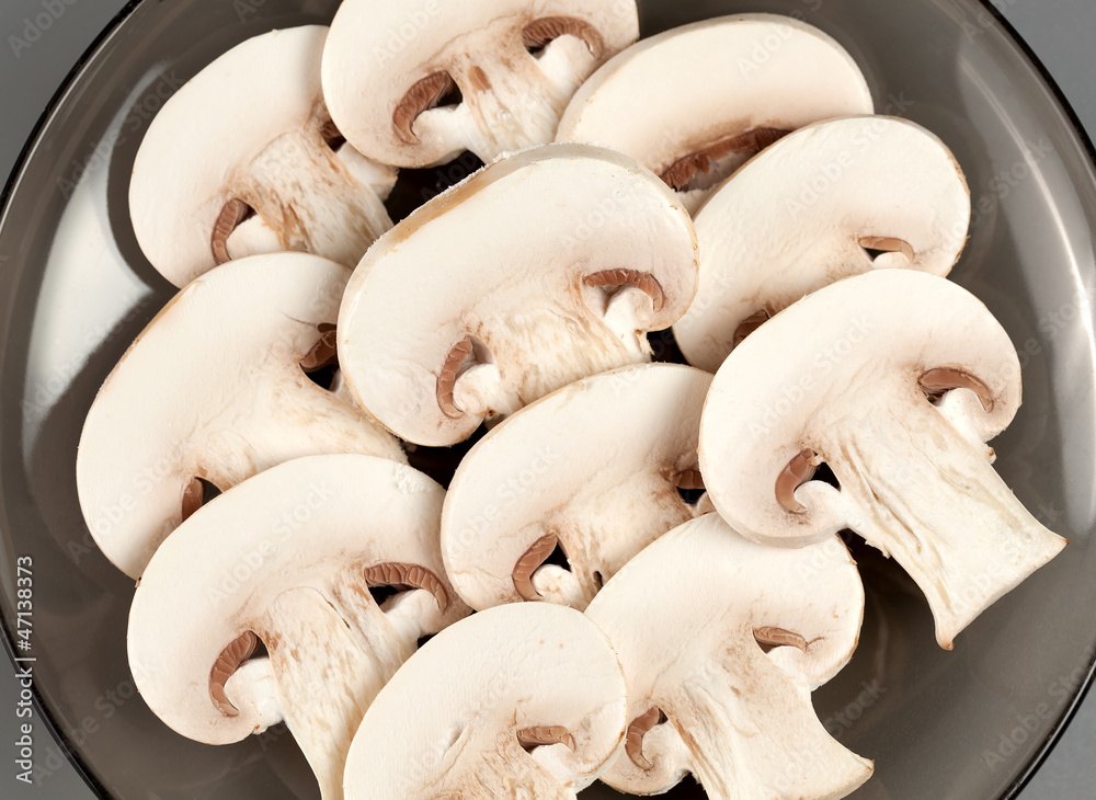 Sliced mushrooms stacked on a plate Sliced mushrooms stacked on a plate